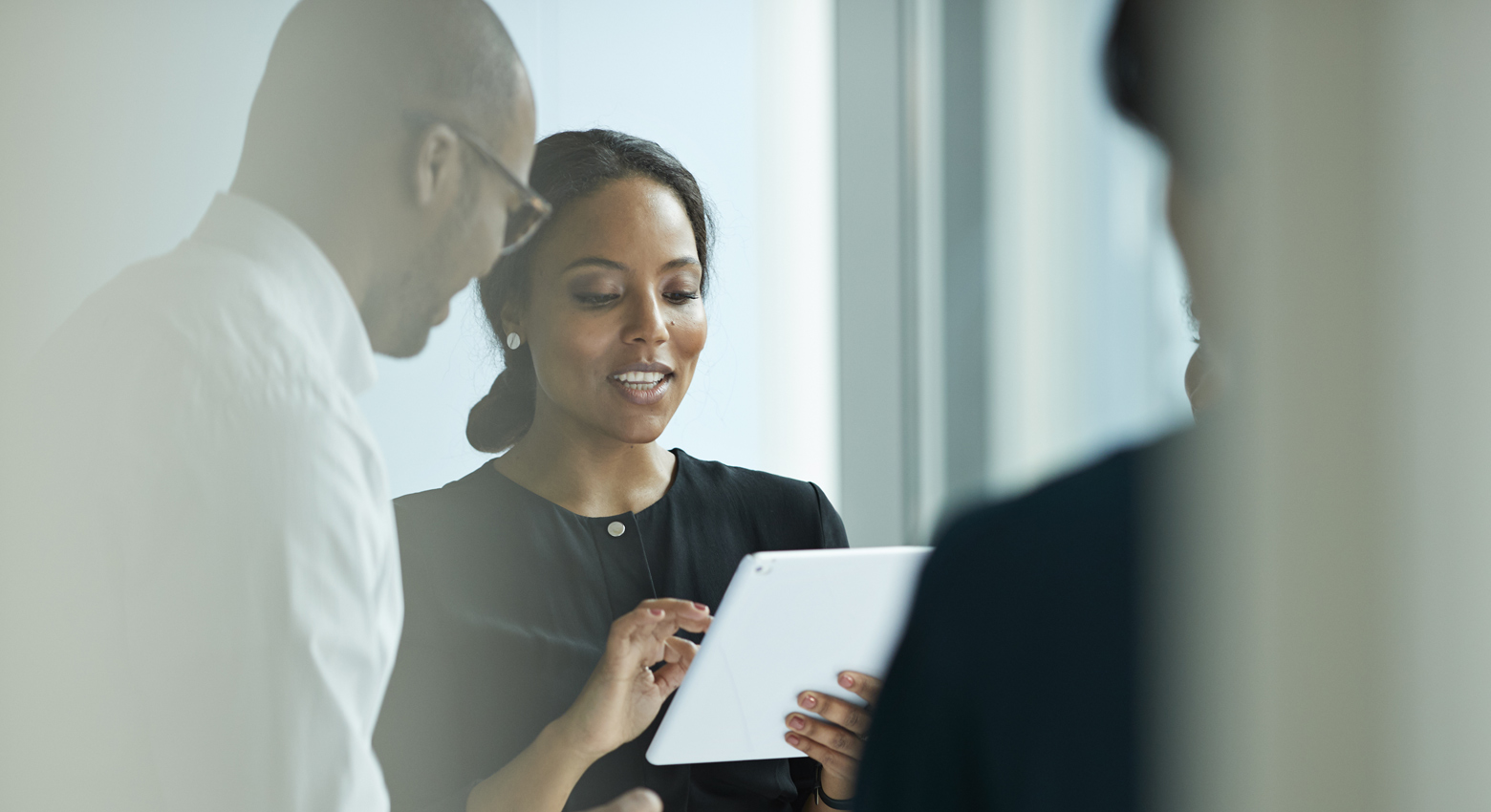 Cliff side at night with winding road and trailing lights 